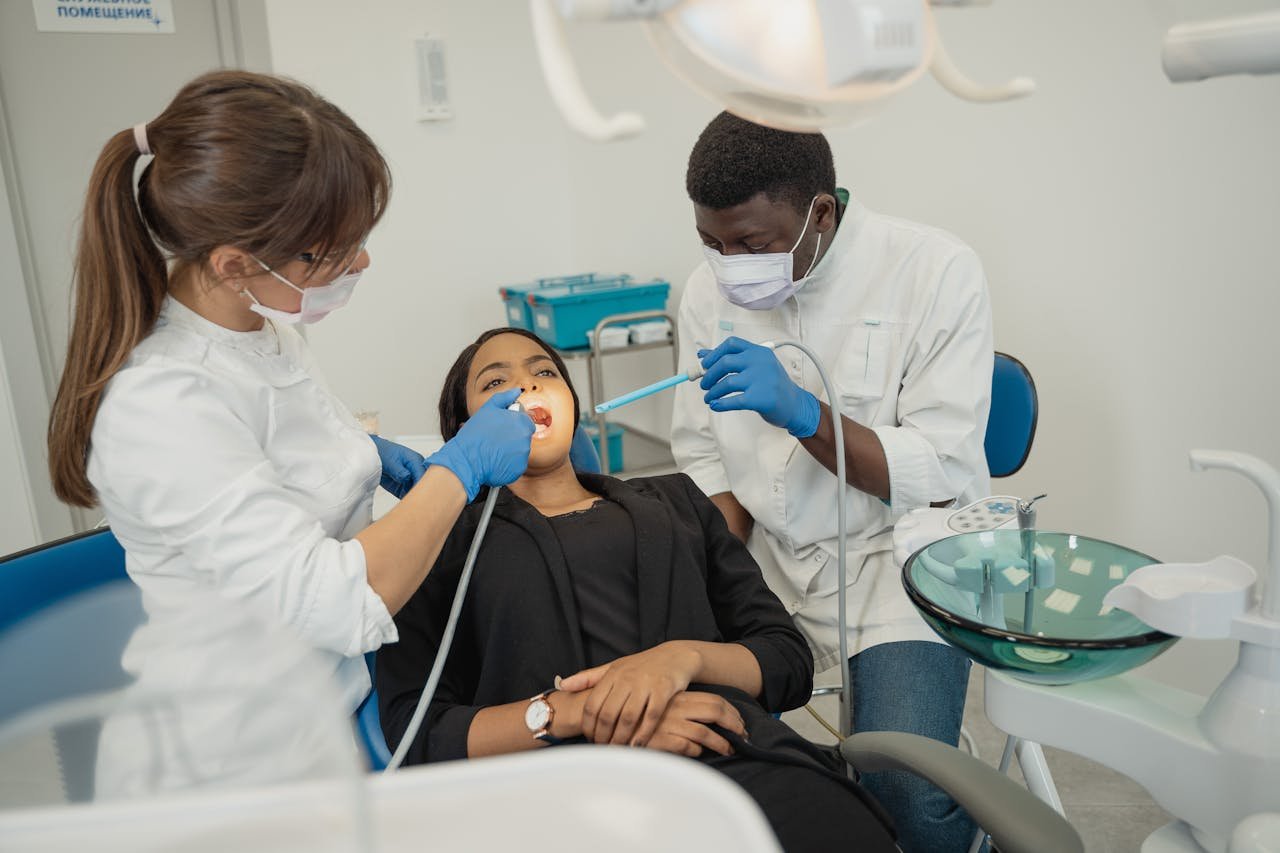 Dentists providing care to a patient in a clean, modern dental clinic.